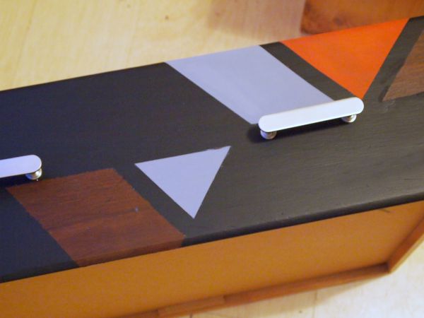 Use tape to create geometric patterns on furniture, it's super easy! 