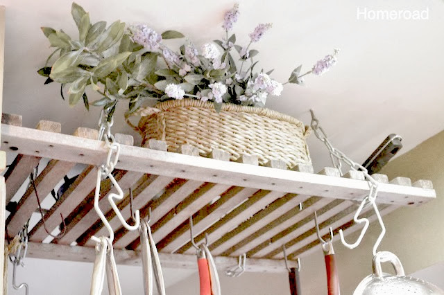 wooden pot rack with pots and plant