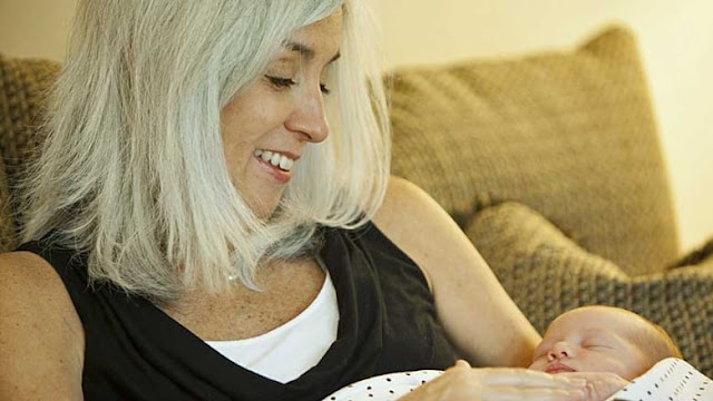 Image: Cindy Reutzel holds her granddaughter Elle Cynthia Jordan Wednesday Sept. 5 after giving birth to her granddaughter on Thursday, Aug. 30 after acting as a surrogate for her own daughter Emily Jordan, who had undergone a radical hysterectomy. (Sitthixay Ditthavong/Associated Press)