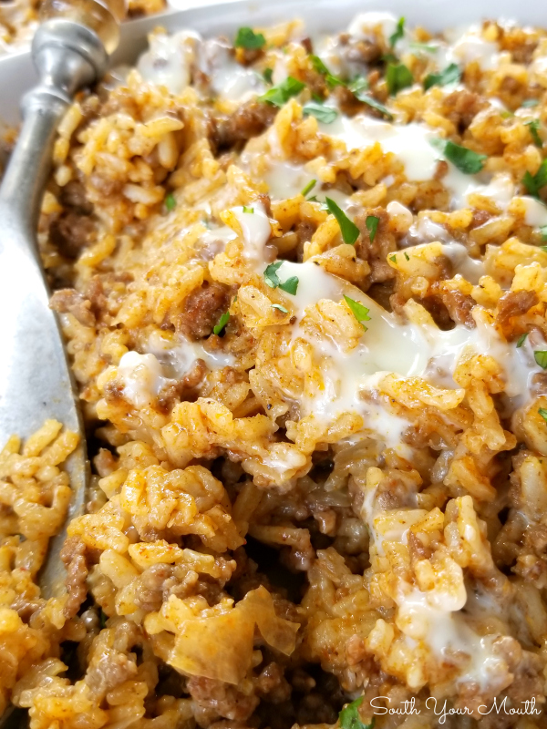 Taco Rice Skillet Dinner with Queso! A one-pan recipe made with ground beef, taco seasoning and Mexican style rice drenched in an easy queso cheese sauce.
