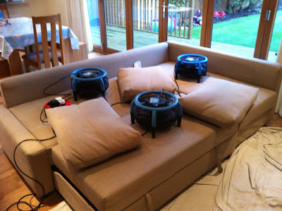 Large fans are used to dry the sofa after cleaning