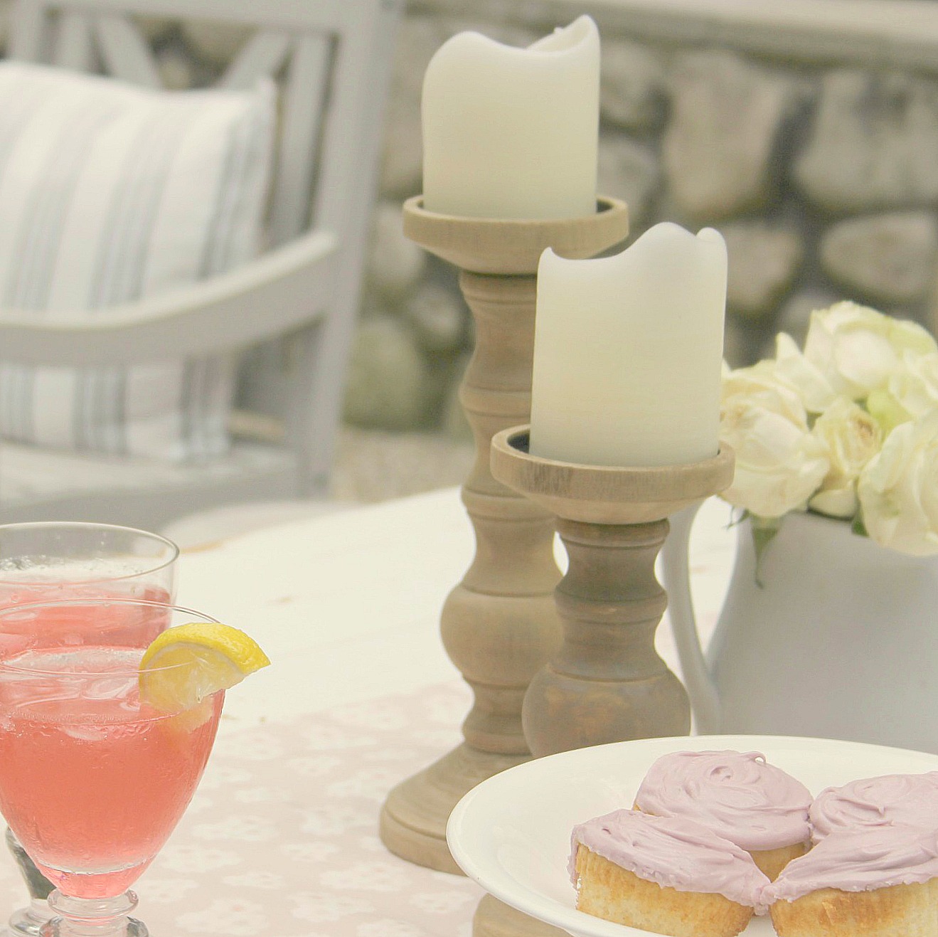 Frosted cupcakes on white ironstone pedestal and pink lemonade - Hello Lovely Studio