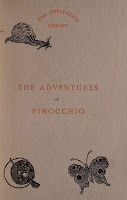 A page reading "The Children's Library The Adventure of Pinocchio" in red text with black decoration.