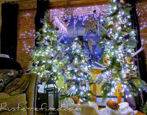 Rustic holiday tree decorating for Christmas. Using Outdoor elements  and a modern style tree, I added woodsy touches such as owls, twigs, burlap, feathers and icicles and plenty of holiday lights. It really brings nature indoors during the cold winter months.