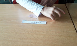 Mão de um aluno a completar um provérbio