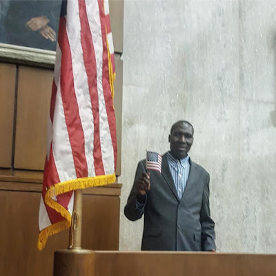 Wilson Komen holding a small US flag at DC Federal Court