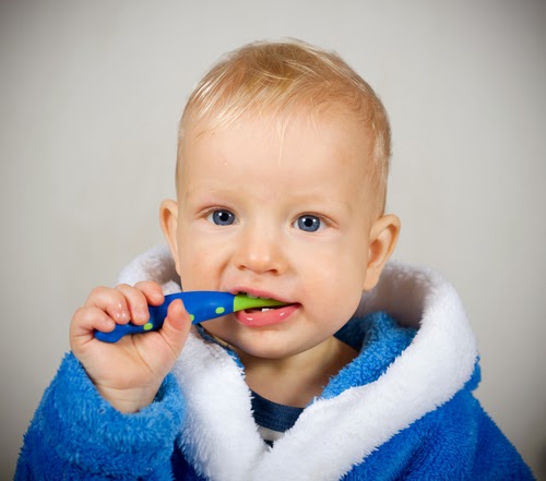 toddler with toothbrush