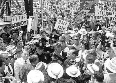 Sen. John F. Kennedy is mobbed by well wishers carrying Kennedy banners on his arrival at Los Angeles International Airport, on July 9, 1960 to personally lead his drive for the Democratic presidential nomination.