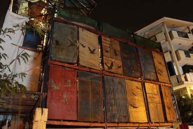 Walker's burnt murals on the flip side of the vertical garden panels