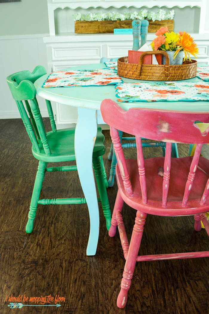 Table and Chairs Makeover with Chalk-Style Paint | Multi-colored chalk style paints and white wax make this vintage piece really pop! Check out the full makeover at ishouldbemoppingthefloor.com.