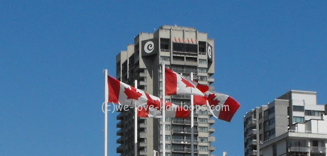 Several flags of Canada flying in the wind in Vancouver