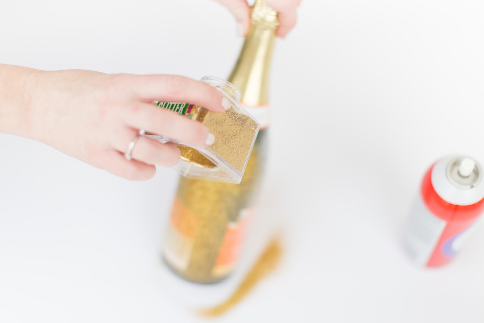 DIY Glitter Champagne Bottle featured by popular party planning blogger, The Celebration Stylist