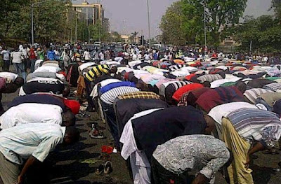 Photo Of The Day: Christians Guarding The Muslims Again As They Say Their Prayers Today During The Occupy Nigeria Protest In Abuja. 1