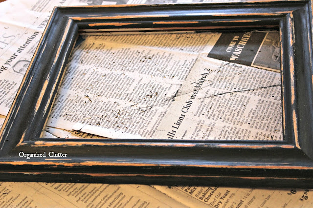 Photo of a distressed black photo frame.