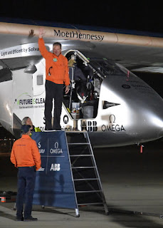 Pilot André Borschberg waves to the crowd before climbing into the cockpit of the Solar Impulse 2, Moffett Field, Mountain View, California