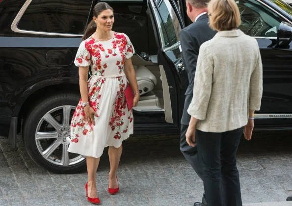 Crown Princess Victoria wore CAMILLA THULIN Alvine Rose White Dress, and Princess Victoria wore Rizzo red shoes and carried a red Rizzo clutch