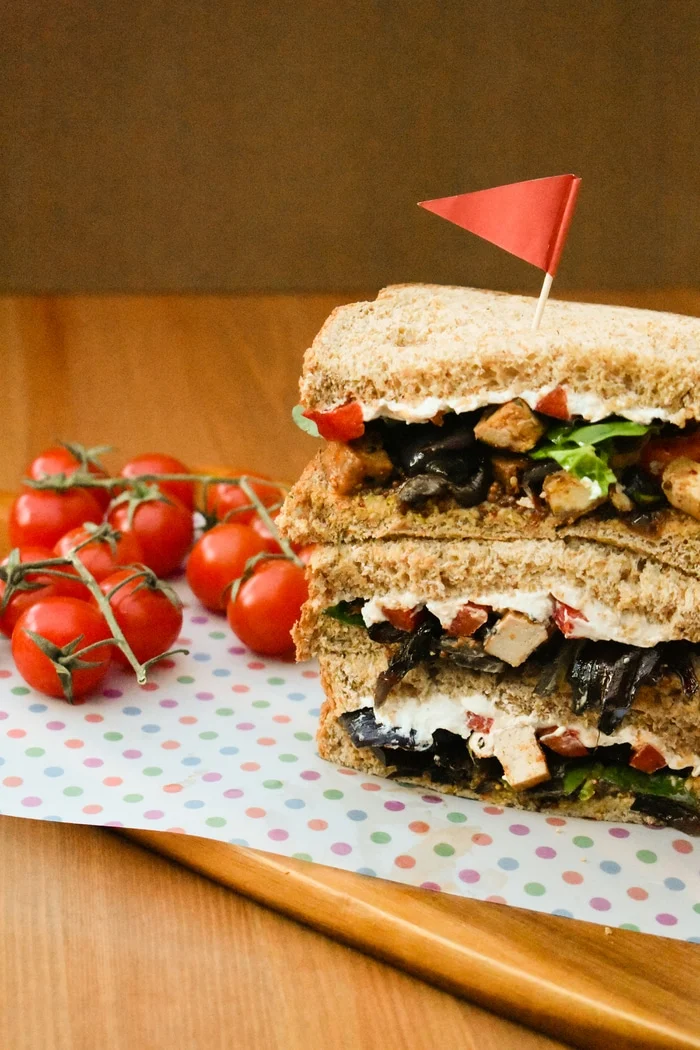 Roasted Vegetable and Tofu Sandwiches. A recipe for luxurious veggie sandwiches. Soft wholemeal bread filled with mustard, salad leaves, roasted vegetables and tofu and cream cheese, plus a meal prep guide.