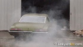 1973 Pontiac Grand Am is smoking heavily and idling outside undisclosed storage facility.