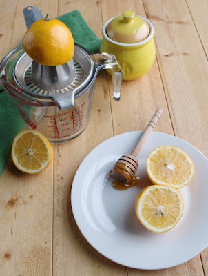 Refreshing and naturally sweetened lemonade is just a few minutes away. This simple drink recipe is a perfect summertime cooler. lemon half on juicer, lemons and honey pot