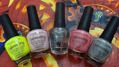 Bottleshots of five Madam Glam Gelementary polishes