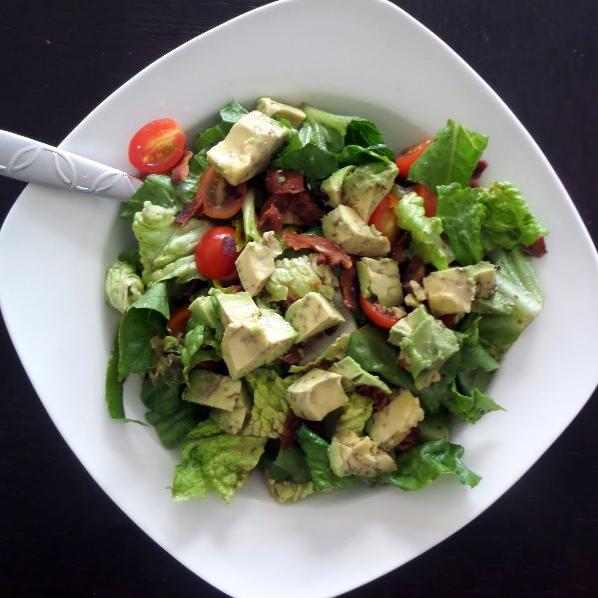 Avocado B.L.T. Salad: Crisp green lettuce tossed in balsamic vinaigrette and topped with crispy bacon, juicy tomatoes, and creamy avocado.