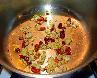 Frying the chiles and garlic in olive oil