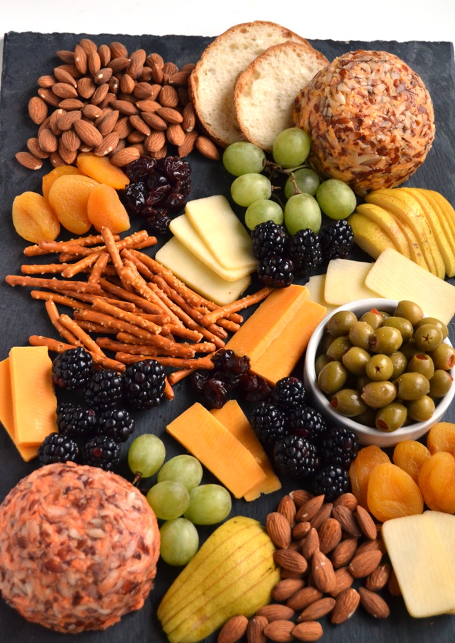 The Ultimate Cheese Board is perfect for entertaining, takes 5 minutes to put together and is filled with your favorite cheeses, nuts, dried fruits, crackers, olives and more! www.nutritionistreviews.com
