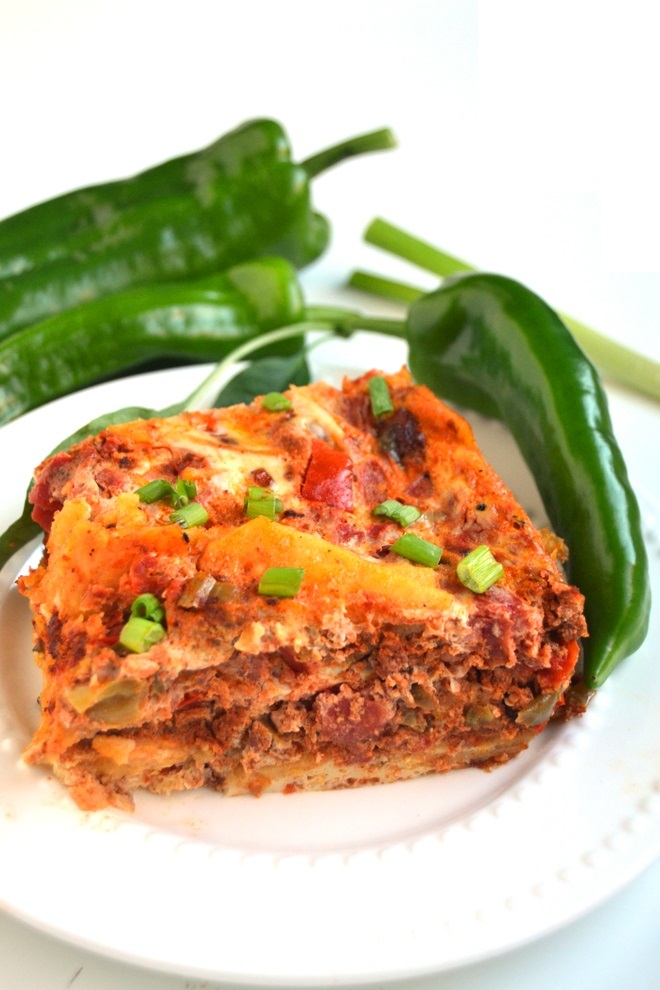 Slow Cooker Enchilada Breakfast Casserole is a delicious egg bake made in the crockpot with chorizo, sauteed bell peppers, tomatoes and corn tortillas! www.nutritionistreviews.com