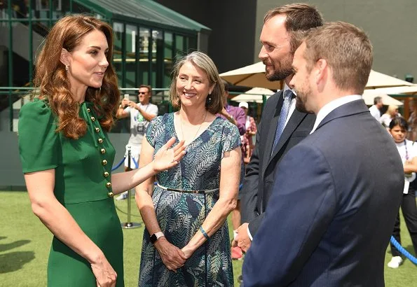 Kate Middleton wore a green midi dress by Dolce & Gabbana. Meghan Markle wore a print midi skirt by Hugo Boss