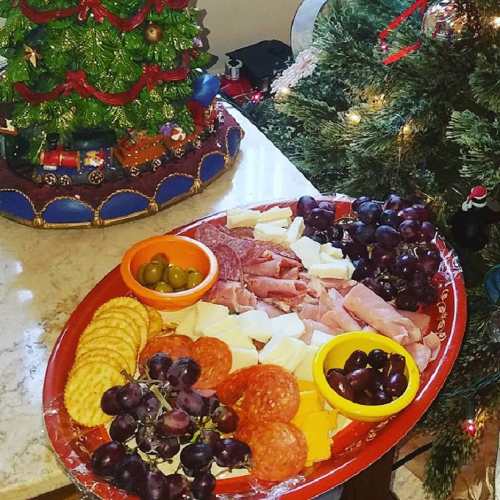 This is a cheese, wine, fruit, olives and board built with all kinds of appetizers to include