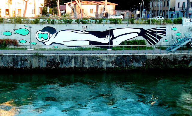 Italian Street Artist MP5 Paints a new mural entitled "Playing Upstream" in Terni, Italy. 2