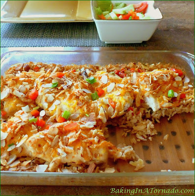 Chicken with Rice Dinner Casserole. Boneless chicken breasts, vegetables and rice cook in the oven in a flavorful broth | Recipe developed by www.BakingInATornado.com | #recipe #dinner #chicken