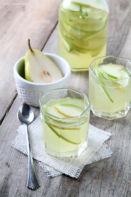 This Apple and Pear White Sangria is the PERFECT drink for fall! Sweet, fruity, and very refreshing! LoveGrowsWild.com