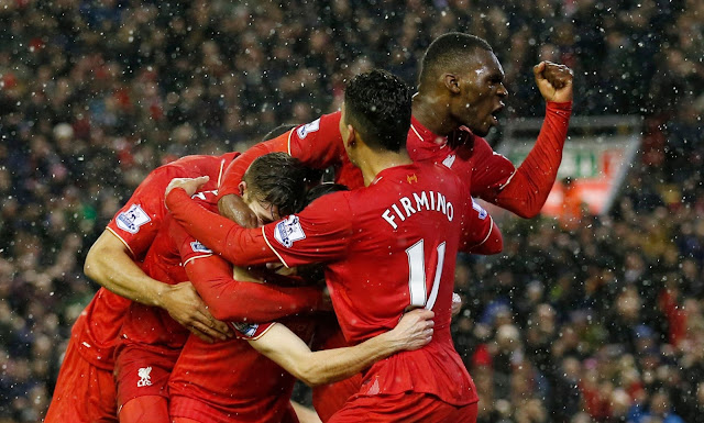 Joe Allen celebrates scoring the third goal for Liverpool with team mates
