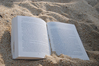 Open book on the sand at a beach
