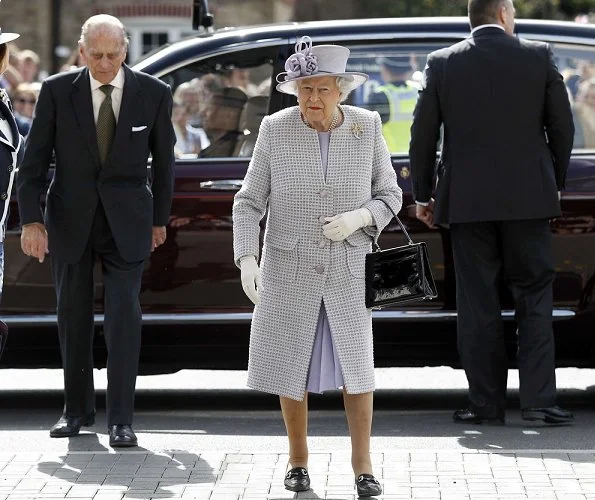 Queen Elizabeth and Prince Philip met the Head Elephant Keeper and view the elephant team carrying out daily care tasks such as nail filing and mouth care