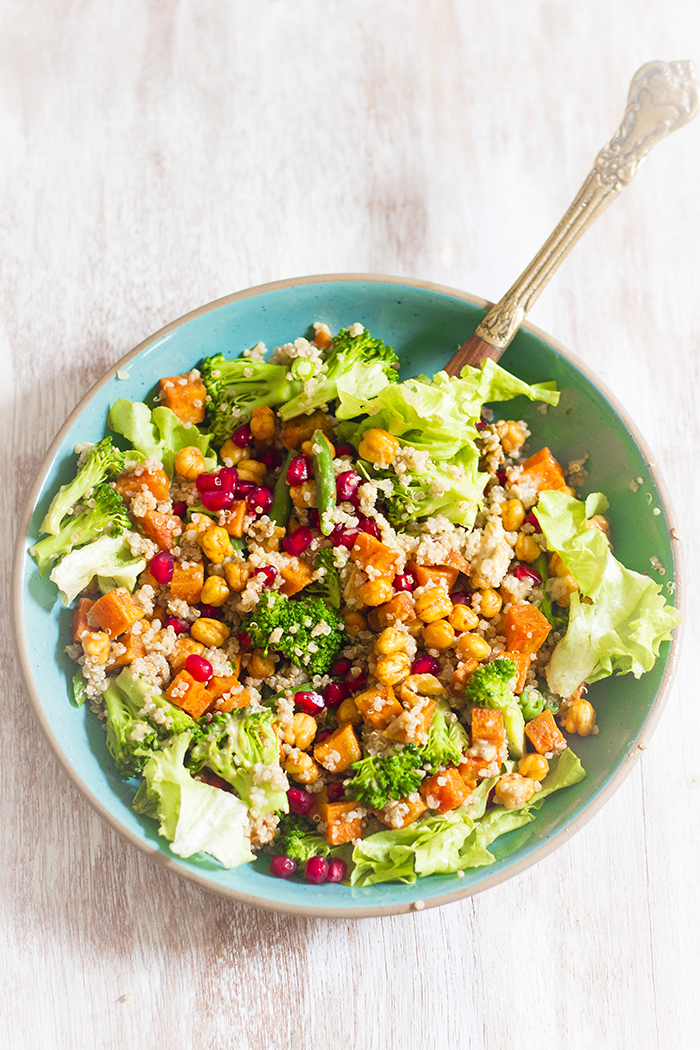 roasted sweet potato, chickpea, quinoa salad with walnuts, pomegranate, broccoli and beans in a mustard date dressing