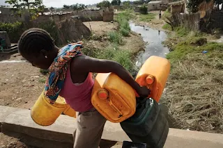 Carrying water home for the family in Nigeria Africa