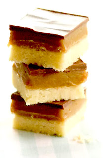 Stack of millionaires shortbread squares topped with caramel toffee and chocolate