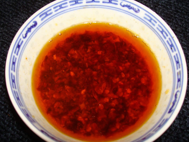 INGREDIENTS  1 tsp. minced ginger  2 minced garlic cloves  1 tbsp. vegetable oil  4 tbsp. sesame oil  11 chopped sichuan dry hot peppers  1 tsp. salt  METHOD  In a small pot heat the vegetable and cook garlic and ginger together. Add the hot peppers and cook for 1 minute. Add sesame oil and salt. Let it cool off.