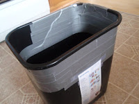 Trash can with duct tape on it