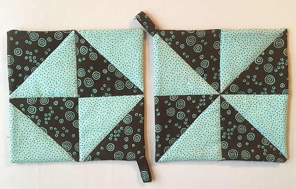 Half-Square Triangle Potholder Tutorial: A super easy beginner project. Plus she shows you a bunch of great tricks for making half square triangles fast and easy! 