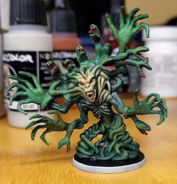 The green was drybrush highlighted then glazed with a green ink. Painted Medusa model