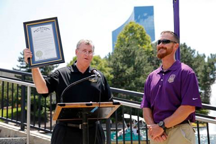Crown Royal's "Your Hero's Name Here" winner and Brickyard 400 race namesake, U.S. Marine Corps Sergeant Jeff Kyle, right, is honored by Indianapolis Mayor Greg Ballard with the proclamation of Jeff Kyle Day  in Indianapolis, Friday, July 24, 2015. (AJ Mast /AP Images for Crown Royal)