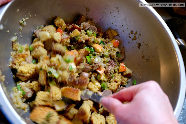 photo showing Apple Sausage Cornbread Stuffing being mixed in a mixing bowl