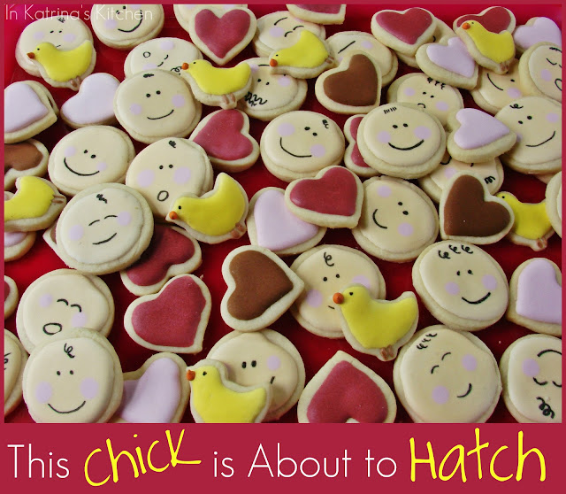 mini cookies made to look like baby faces shown with hearts and baby chick cookies