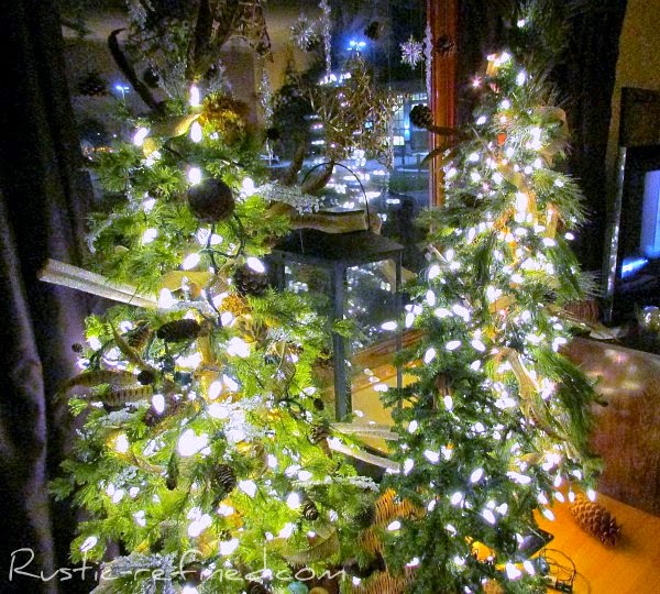 Rustic holiday tree decorating for Christmas. Using Outdoor elements  and a modern style tree, I added woodsy touches such as owls, twigs, burlap, feathers and icicles and plenty of holiday lights. It really brings nature indoors during the cold winter months.
