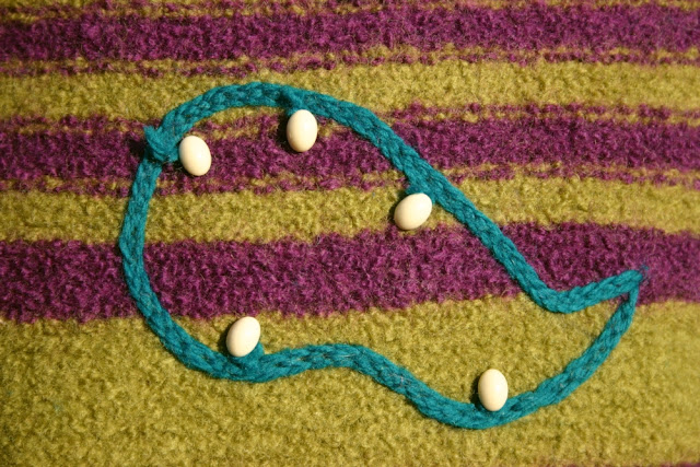 'Skat' Felted knit pillow detail Hungarian braided chain stitch