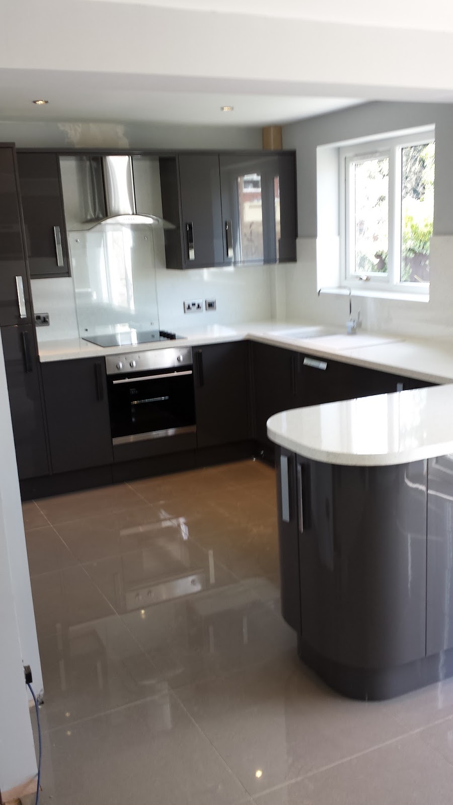 Elm Kitchens and Joinery Howdens Kitchen in dark grey gloss with a