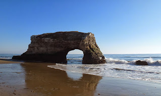 One large rock formation  with a arch large enough for two or three people to walk through sits in the tidal zone at Natural Bridges.